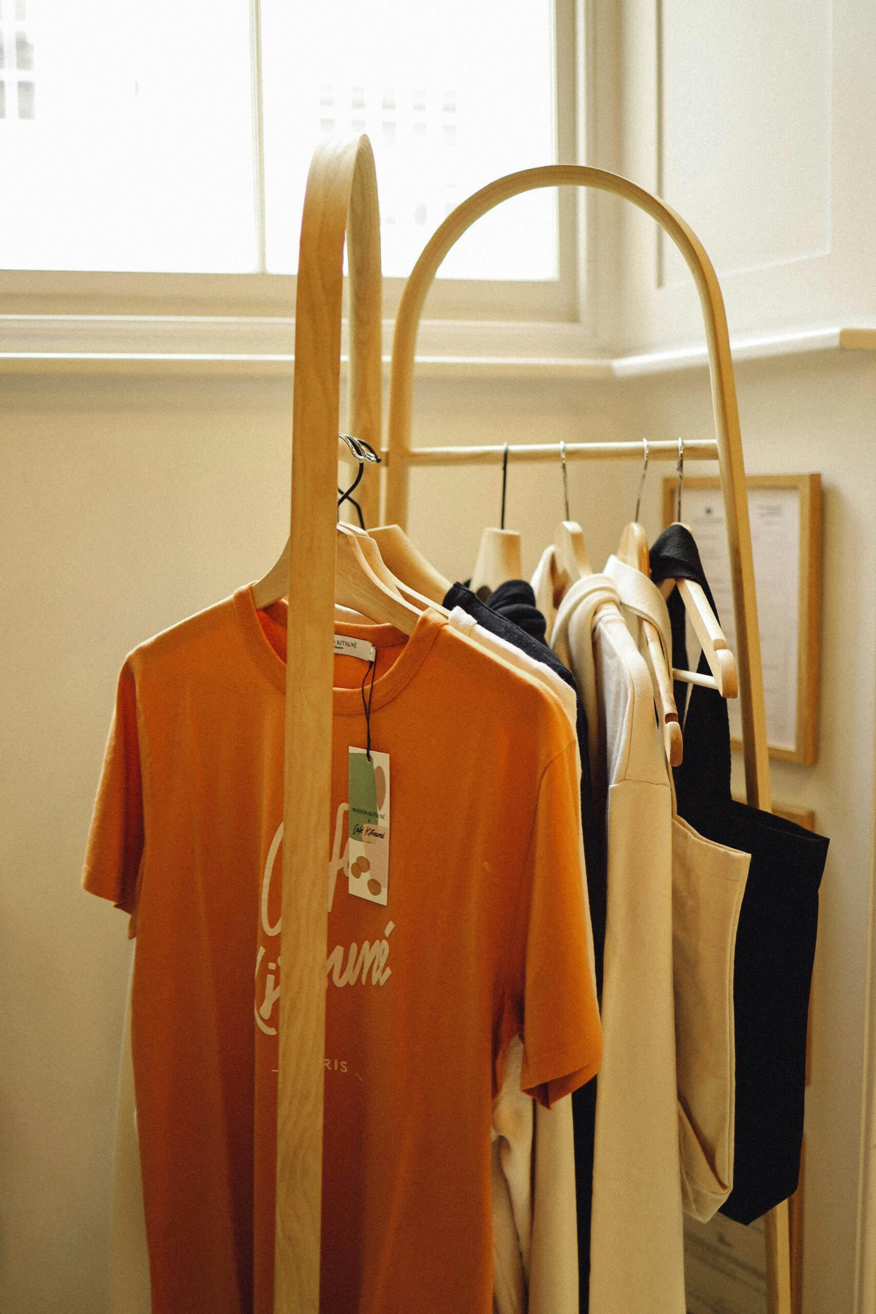 A modern clothing rack displaying a variety of stylish shirts in a boutique setting.